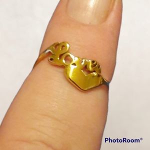 Pretty little goldtone love ring.